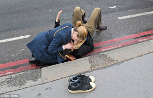 A women comforts a victim who survived the attack with injuries. Several people have serious injuries. A women comforts a victim who survived the attack with injuries. Several people have serious injuries.