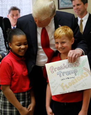 President Trump posed for a picture with two students from St. Andrew Catholic School, telling them 'Come on, kids. We're going to make you famous.' (CNS) President Trump posed for a picture with two students from St. Andrew Catholic School, telling them 'Come on, kids. We're going to make you famous.' (CNS)