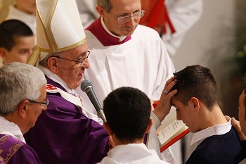 Pope Francis conferring the Sacrament of Confirmation on a young man. Pope Francis conferring the Sacrament of Confirmation on a young man.