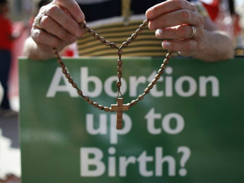 A protestor prays as the BMA debates Measure 50. A protestor prays as the BMA debates Measure 50.