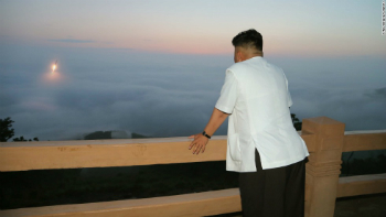 Kim Jong Un views a launch from a distance. Kim Jong Un views a launch from a distance.