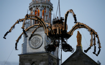 The giant spider woke up on cue, and walked into the streets below, amazing the crowd. But not everybody appreciated the display. The giant spider woke up on cue, and walked into the streets below, amazing the crowd. But not everybody appreciated the display.