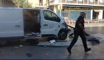 An officer walks past the van used in the attack. An officer walks past the van used in the attack.