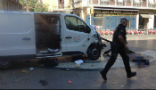 An officer walks past the van used in the attack. Image of An officer walks past the van used in the attack.