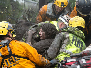 A woman is rescued by firefighters. At least 15 are dead, and search and rescue efforts are ongoing. A woman is rescued by firefighters. At least 15 are dead, and search and rescue efforts are ongoing.