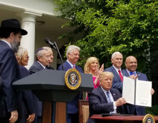 Priests for Life's Alveda King, second from left, watches as President Trump signs an executive order on religious liberty in May 2017. Priests for Life's Alveda King, second from left, watches as President Trump signs an executive order on religious liberty in May 2017.