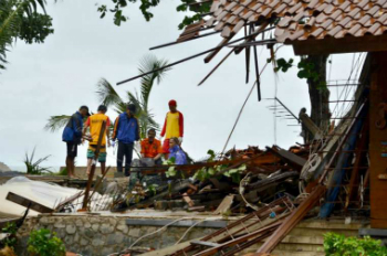 Officials look through the wreckage of damaged buildings in Carita, Indonesia on December 23, 2018. Credit: AFP/Getty Images. Officials look through the wreckage of damaged buildings in Carita, Indonesia on December 23, 2018. Credit: AFP/Getty Images.
