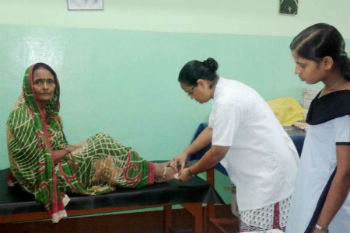 Sr. Philomena Guria RNDM treating a snake bite patient Sr. Philomena Guria RNDM treating a snake bite patient