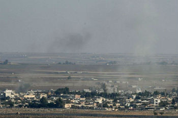 Smoke rises from the Syrian town of Ras al Ayn during the Turkish offensive against Kurdish groups in northeastern Syria Oct. 17 2019 as seen from Turkey. Smoke rises from the Syrian town of Ras al Ayn during the Turkish offensive against Kurdish groups in northeastern Syria Oct. 17 2019 as seen from Turkey.
