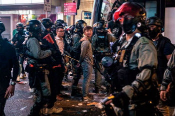 Riot police detain two men after clearing protesters from the Central district in Hong Kong Riot police detain two men after clearing protesters from the Central district in Hong Kong