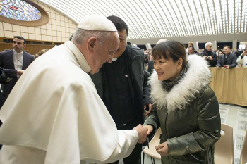 Pope Francis greets a woman after the general audience Image of Pope Francis greets a woman after the general audience
