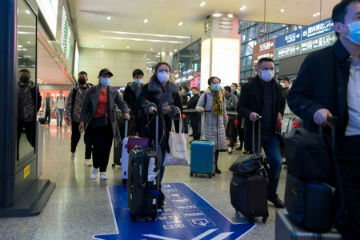 Travelers wearing masks Image of Travelers wearing masks