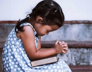 Praying is a way for kids to communicate with our savior. Image of Praying is a way for kids to communicate with our savior.