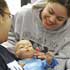 STUDENTS TEND TO DOLL BABIES – Junior Jazleen Rosado, left, and senior Marilin Torres tend to their Image of STUDENTS TEND TO DOLL BABIES – Junior Jazleen Rosado, left, and senior Marilin Torres tend to their