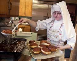 NUN FILLS PRE-LENTEN PASTRY – Sister Patrycja Bryniarska fills paczki dough with jelly at the Albertine Home in Hammond, Ind., Feb. 23. The traditional Polish pastries are said to have come about as a way to do away with rich ingredients that could not be consumed during Lent. (CNS photo/Northwest Indiana Catholic) Image of NUN FILLS PRE-LENTEN PASTRY – Sister Patrycja Bryniarska fills paczki dough with jelly at the Albertine Home in Hammond, Ind., Feb. 23. The traditional Polish pastries are said to have come about as a way to do away with rich ingredients that could not be consumed during Lent. (CNS photo/Northwest Indiana Catholic)
