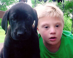 BOY WITH DOWN SYNDROME POSES WITH DOG AT NORTH DAKOTA HOME
Colten Schneider poses with his dog D.J. at his home in Fargo, N.D. The 8-year-old boy, who with his family attends St. Anthony Church in Selz, has Down syndrome. He struggles to express himself verbally, but his family and his friends almost always kno w exactly what he is saying. (CNS photo/courtesy Schneider family).
Image of BOY WITH DOWN SYNDROME POSES WITH DOG AT NORTH DAKOTA HOME
Colten Schneider poses with his dog D.J. at his home in Fargo, N.D. The 8-year-old boy, who with his family attends St. Anthony Church in Selz, has Down syndrome. He struggles to express himself verbally, but his family and his friends almost always kno w exactly what he is saying. (CNS photo/courtesy Schneider family).