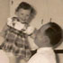 TENDER MOMENT - A father, George, balances his daughter, Mary, on his hand in the family kitchen. George's journey of faith and hope is revealed in this Father's Day story. Image of TENDER MOMENT - A father, George, balances his daughter, Mary, on his hand in the family kitchen. George's journey of faith and hope is revealed in this Father's Day story.