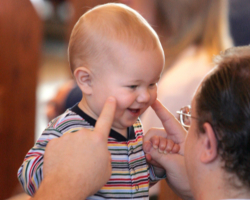 FATHER AND SON SHARE A LIGHT MOMENT DURING MASS – A father and his young child share a light moment during a 2005 Mass at St. John Vianney Church in Prince Frederick, Md. Fathers receive special recognition on Father's Day, which falls on in many countries including the United States on June 18 this year. (CNS) Image of FATHER AND SON SHARE A LIGHT MOMENT DURING MASS – A father and his young child share a light moment during a 2005 Mass at St. John Vianney Church in Prince Frederick, Md. Fathers receive special recognition on Father's Day, which falls on in many countries including the United States on June 18 this year. (CNS)