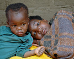 CHILD SITS NEXT TO ILL MOTHER - One of her children sits next to an ailing Lydia Kathebwe, 31, infected with HIV, in the Zamba district of Malawi in this photo taken in late May. Father John Garvey explores the issue of suffering, asking whether God can be all powerful and all good and the world be a place of much misery. (CNS/The Catholic Register)
Image of CHILD SITS NEXT TO ILL MOTHER - One of her children sits next to an ailing Lydia Kathebwe, 31, infected with HIV, in the Zamba district of Malawi in this photo taken in late May. Father John Garvey explores the issue of suffering, asking whether God can be all powerful and all good and the world be a place of much misery. (CNS/The Catholic Register)