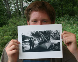 VOLUNTEER GRAD TO RETURN TO NEW ORLEANS: Patrick Semansky shows a photo of a boat left in the streets of New Orleans after Hurricane Katrina and the flooding caused by the break in the levee. (Photo/Mary Carty) Image of VOLUNTEER GRAD TO RETURN TO NEW ORLEANS: Patrick Semansky shows a photo of a boat left in the streets of New Orleans after Hurricane Katrina and the flooding caused by the break in the levee. (Photo/Mary Carty)