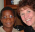 SISTER PARISH PROVIDES OPTICAL SUPPORT: Sally VanBuskirk (right), a leader volunteer for the Jamaica Outreach Program, sits with one of the children that was given glasses as part of the eye care program at St. Pius X parish in Kingston, Jamaica. (Photo/Jamaica Outreach Program) Image of SISTER PARISH PROVIDES OPTICAL SUPPORT: Sally VanBuskirk (right), a leader volunteer for the Jamaica Outreach Program, sits with one of the children that was given glasses as part of the eye care program at St. Pius X parish in Kingston, Jamaica. (Photo/Jamaica Outreach Program)