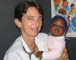 DOCTOR HOLDS CHILD IN HER CARE - Dr. Ellen Einterz holds a child in her care from a hospital in the African country of Cameroon, where malaria, malnutrition, cholera and AIDS are constant companions. She and her brother, Bob Einterz, a founder of IU-Kenya Partnership, both draw on their faith to work on behalf of the poor and suffering of Africa. (The Criterion) Image of DOCTOR HOLDS CHILD IN HER CARE - Dr. Ellen Einterz holds a child in her care from a hospital in the African country of Cameroon, where malaria, malnutrition, cholera and AIDS are constant companions. She and her brother, Bob Einterz, a founder of IU-Kenya Partnership, both draw on their faith to work on behalf of the poor and suffering of Africa. (The Criterion)