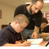 TEACHER WORKS WITH STUDENT WHO HAS DOWN SYNDROME - Mike Gittings, a geometry teacher at Mount St. Joseph High School in Baltimore, Md., helps Ben Stevick with a geometry problem in late September. Ben, a 17-year-old sophomore, is the first student with Down syndrome to enroll in a Catholic high school in the Archdiocese of Baltimore. (CNS/Catholic Review) Image of TEACHER WORKS WITH STUDENT WHO HAS DOWN SYNDROME - Mike Gittings, a geometry teacher at Mount St. Joseph High School in Baltimore, Md., helps Ben Stevick with a geometry problem in late September. Ben, a 17-year-old sophomore, is the first student with Down syndrome to enroll in a Catholic high school in the Archdiocese of Baltimore. (CNS/Catholic Review)