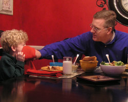 LENTEN FOOD FOR THOUGHT – Howard Egger wipes the face of his son, Charlie, during dinner – a time when the Egger family regroups and prays together. The start of Lent provides food for thought, not only about food but about the importance of the Lenten season in the faith lives of people. (The Criterion) Image of LENTEN FOOD FOR THOUGHT – Howard Egger wipes the face of his son, Charlie, during dinner – a time when the Egger family regroups and prays together. The start of Lent provides food for thought, not only about food but about the importance of the Lenten season in the faith lives of people. (The Criterion)