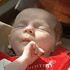 INDIANAPOLIS BABY BORN WITH RARE TUMOR SLEEPS IN FATHER'S ARMS - Anne Therese Felts of Indianapolis sleeps in her father's arms in early February. At 27 weeks gestation, the fourth child of St. Simon the Apostle parishioners Chris and Paje Felts of Indianapolis was diagnosed with having a rare pericardial teratoma -- a racquetball-size tumor attached to her heart. She overcame overwhelming odds during the hours and days after her premature birth Dec. 28, 2006. (CNS photo/Mary Ann Wyand, The Criterion) Image of INDIANAPOLIS BABY BORN WITH RARE TUMOR SLEEPS IN FATHER'S ARMS - Anne Therese Felts of Indianapolis sleeps in her father's arms in early February. At 27 weeks gestation, the fourth child of St. Simon the Apostle parishioners Chris and Paje Felts of Indianapolis was diagnosed with having a rare pericardial teratoma -- a racquetball-size tumor attached to her heart. She overcame overwhelming odds during the hours and days after her premature birth Dec. 28, 2006. (CNS photo/Mary Ann Wyand, The Criterion)