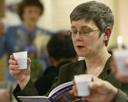 WOMAN PARTICIPATES IN SEDER MEAL – Sandra Steele lifts a cup of grape juice, symbolizing wine, during a Seder meal at St. Thomas More Church in Munster, Ind., March 24. The Seder is a special ritual during the Jewish festival of Passover, a holiday commemorating Jewish deliverance from Egyptian bondage and the time of the barley season. Many Catholics participate in a Seder during the season of Lent. (CNS/Northwest Indiana Catholic) Image of WOMAN PARTICIPATES IN SEDER MEAL – Sandra Steele lifts a cup of grape juice, symbolizing wine, during a Seder meal at St. Thomas More Church in Munster, Ind., March 24. The Seder is a special ritual during the Jewish festival of Passover, a holiday commemorating Jewish deliverance from Egyptian bondage and the time of the barley season. Many Catholics participate in a Seder during the season of Lent. (CNS/Northwest Indiana Catholic)