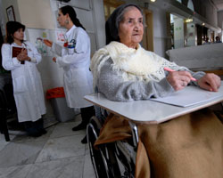 PATIENT WRITES OUT PRAYERS AT JERUSALEM HOSPICE FACILITY – Sister Constancia Francis, 82, writes out prayers as therapist Tammy Einstein, center, consults with another staff member at Saint-Louis Hospital in Jerusalem March 22. The facility, run by the Sisters of St. Joseph of the Apparition, provides hospice and geriatric care to Jerusalem residents of any race, religion or nationality. (CNS photo/Debbie Hill)
Image of PATIENT WRITES OUT PRAYERS AT JERUSALEM HOSPICE FACILITY – Sister Constancia Francis, 82, writes out prayers as therapist Tammy Einstein, center, consults with another staff member at Saint-Louis Hospital in Jerusalem March 22. The facility, run by the Sisters of St. Joseph of the Apparition, provides hospice and geriatric care to Jerusalem residents of any race, religion or nationality. (CNS photo/Debbie Hill)