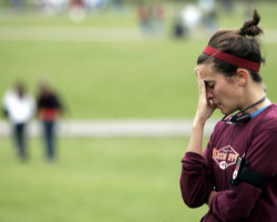 STUDENT GRIEVES AT MEMORIAL TO SHOOTING VICTIMS – A student grieves at a campus memorial for the Virginia Tech shooting victims in Blacksburg, Va., April 19. Student Cho Seung-Hui, 23, killed 32 people and then took his own life April 16 at the university. (CNS/Reuters) Image of STUDENT GRIEVES AT MEMORIAL TO SHOOTING VICTIMS – A student grieves at a campus memorial for the Virginia Tech shooting victims in Blacksburg, Va., April 19. Student Cho Seung-Hui, 23, killed 32 people and then took his own life April 16 at the university. (CNS/Reuters)