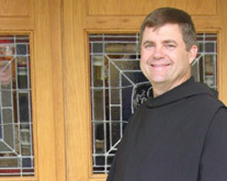BROTHER PATRICK'S LIFE CHANGED ONCE HER HEARD SPIRT IN OTHERS - Brother Patrick Boland, OSB, wears his simple Benedictine habit, which includes a black cassock, leather belt and scapular (similar to priest's alb, minus the sides) with attached capoch (hood). (Photo/Arkansas Catholic)
Image of BROTHER PATRICK'S LIFE CHANGED ONCE HER HEARD SPIRT IN OTHERS - Brother Patrick Boland, OSB, wears his simple Benedictine habit, which includes a black cassock, leather belt and scapular (similar to priest's alb, minus the sides) with attached capoch (hood). (Photo/Arkansas Catholic)