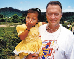 DOCTOR SHARES MEDICAL SKILLS - Deacon Dr. Don Greenway holds a 3-year-old Honduran patient in the village of Guadalupe Carney during the March 2004 Christ the King medical mission. (Photo Arkansas Catholic)
Image of DOCTOR SHARES MEDICAL SKILLS - Deacon Dr. Don Greenway holds a 3-year-old Honduran patient in the village of Guadalupe Carney during the March 2004 Christ the King medical mission. (Photo Arkansas Catholic)