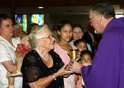VOCATIONS EFFORT - Surrounded by family members, Joyce Evans receives a chalice from Monsignor Stephen Bosso of St. Vincent de Paul Regional Seminary, who presided during Mass at St. Vincent Ferrer Parish.(FC/Linda Reeves)
<br> Image of VOCATIONS EFFORT - Surrounded by family members, Joyce Evans receives a chalice from Monsignor Stephen Bosso of St. Vincent de Paul Regional Seminary, who presided during Mass at St. Vincent Ferrer Parish.(FC/Linda Reeves)
<br>