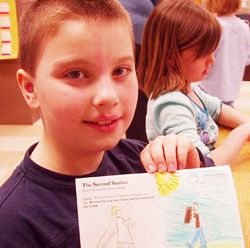 THE STATIONS, ILLUSTRATED - Second grader Zach Olds displays one of the pages in his booklet. (Catholic Herald/Mary Grieco) Image of THE STATIONS, ILLUSTRATED - Second grader Zach Olds displays one of the pages in his booklet. (Catholic Herald/Mary Grieco)