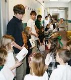 STATION TO STATION - Sophomore theology students from Archbishop Bergan Catholic High School hold the Stations of the Cross while kindergartners and first graders at Archbishop Bergan Elementary move from station to station Feb. 22. Reading the station is Lauren Glowacki. (Lisa Maxson/Staff)
<br> Image of STATION TO STATION - Sophomore theology students from Archbishop Bergan Catholic High School hold the Stations of the Cross while kindergartners and first graders at Archbishop Bergan Elementary move from station to station Feb. 22. Reading the station is Lauren Glowacki. (Lisa Maxson/Staff)
<br>