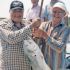 FISHER OF MEN... AND FISH - Msgr. Larry Stuebben and Anthony Kallina display the monsignor’s prize catch on a fishing expedition at Port O’Connor, a pastime he squeezes into his still very active ministry schedule for the archdiocese. Image of FISHER OF MEN... AND FISH - Msgr. Larry Stuebben and Anthony Kallina display the monsignor’s prize catch on a fishing expedition at Port O’Connor, a pastime he squeezes into his still very active ministry schedule for the archdiocese.