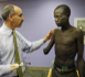 Alberto Esquenazi M.D., director of the amputee program, left, talks to Ronald Okello about a prosthetic arm at Einstein-Moss Rehab in Elkins Park, May 11, 2008. For Okello, 18, a veteran of Uganda's civil war, a $10,000 prosthetic arm means getting his life back. (Michael S. Wirtz/Philadelphia Inquirer/MCT) Image of Alberto Esquenazi M.D., director of the amputee program, left, talks to Ronald Okello about a prosthetic arm at Einstein-Moss Rehab in Elkins Park, May 11, 2008. For Okello, 18, a veteran of Uganda's civil war, a $10,000 prosthetic arm means getting his life back. (Michael S. Wirtz/Philadelphia Inquirer/MCT)