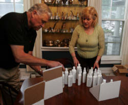 Buz and Gay Fishter package their Parsley Hollow All Natural Pet Products in hte dining room of their Wooster home. (Lew Stamp/Akron Beacon Journal) Image of Buz and Gay Fishter package their Parsley Hollow All Natural Pet Products in hte dining room of their Wooster home. (Lew Stamp/Akron Beacon Journal)