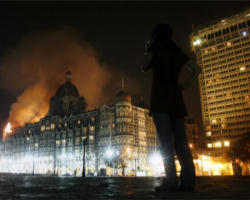 A woman reacts, during a candle-light march for the victims of the Mumbai terrorist attack in which more than 195 people were killed, in Mumbai, India. Image of A woman reacts, during a candle-light march for the victims of the Mumbai terrorist attack in which more than 195 people were killed, in Mumbai, India.