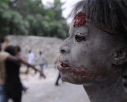 The body of a little girl lies in rubble in Port au Prince, Haiti, Wednesday, Jan. 13, 2010. Image of The body of a little girl lies in rubble in Port au Prince, Haiti, Wednesday, Jan. 13, 2010.