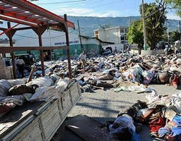 Rescuers cover a corpse retrieved amid the ruins of a building demolished by an earthquake in Port-au-Prince. Tens of thousands of people are feared dead in Haiti after a calamitous earthquake razed homes, hotels, and hospitals, leaving the capital in ruins and bodies strewn in the streets. Image of Rescuers cover a corpse retrieved amid the ruins of a building demolished by an earthquake in Port-au-Prince. Tens of thousands of people are feared dead in Haiti after a calamitous earthquake razed homes, hotels, and hospitals, leaving the capital in ruins and bodies strewn in the streets.