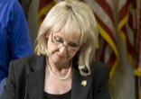 The Governor of Arizona signing the controversial legislation. Image of The Governor of Arizona signing the controversial legislation.