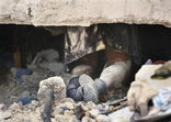 The legs of a school girl named Ruth, no last name known, are seen underneath the collapsed rubble of St. Gerard School after she died at the earthquake in Port-au-Prince, Haiti, Thursday, Jan. 14, 2010. Image of The legs of a school girl named Ruth, no last name known, are seen underneath the collapsed rubble of St. Gerard School after she died at the earthquake in Port-au-Prince, Haiti, Thursday, Jan. 14, 2010.