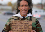 Ted Williams displays the sign he used to beg for money along a highway in Columbus, Ohio. Image of Ted Williams displays the sign he used to beg for money along a highway in Columbus, Ohio.