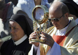 Local priest carries the consecrated host in a procession before about 1000 of the Catholic faithful in Poland Image of Local priest carries the consecrated host in a procession before about 1000 of the Catholic faithful in Poland