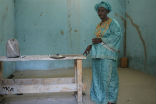 Slalaka Djike stands in the jail cell where she was held for three days awaiting punishment. Image of Slalaka Djike stands in the jail cell where she was held for three days awaiting punishment.