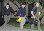 Authorities left the apartment with several bags of evidence. Image of Authorities left the apartment with several bags of evidence.