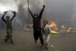 Pakistani men rejoice after burning Christian homes during an anti-Christian riot earlier this year. Image of Pakistani men rejoice after burning Christian homes during an anti-Christian riot earlier this year.